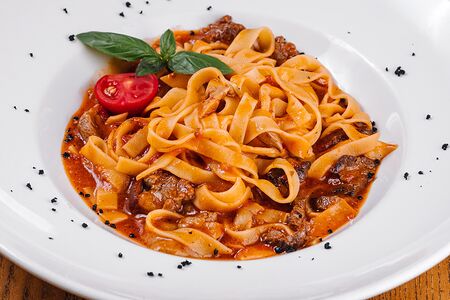 Феттуччине с телятиной и белыми грибами в томатном соусе 