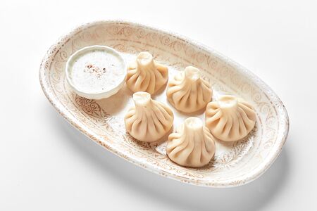 Мини-хинкали с лососем и соусом Том Ям