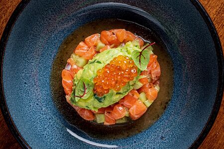 Тартар из лосося с кремом из авокадо и красной икрой