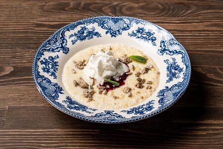 Каша пшенная с халвой, муссом из сметаны и соусом из брусники и клюквы