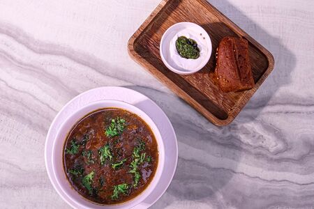 Щи с томлёной щекой, белые грибы, песто из черемши