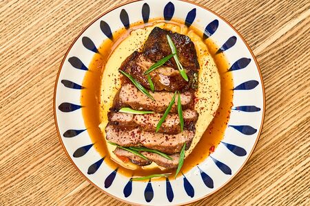 Стейк из свиной шеи с картофельным пюре и печёными овощами