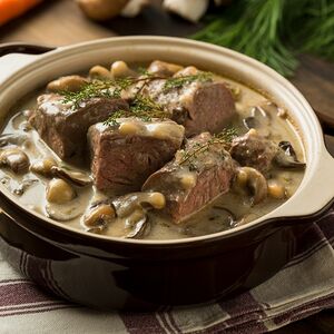 Томленый говяжий язык с грибами в сливочном соусе