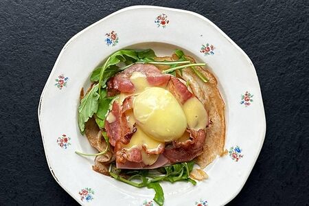 Блин -бенедикт с ветчиной, беконом и томатами, яйцом пашот