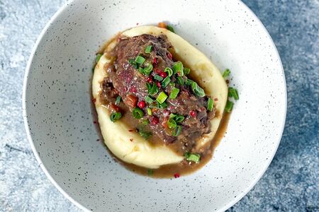 Копченые говяжьи щеки в соусе Демигласс с картофельным пюре и зеленым луком 