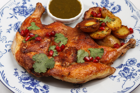 Цыпленок табака с молодой картошкой и зеленым ткемали