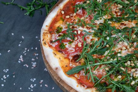 Пицца с моцареллой, помидорами и листьями рукколы