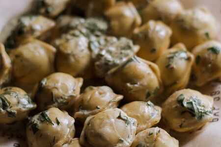 Жареные пельмени в сливочном соусе с зеленью