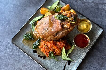 Запеченная свиная рулька с картофелем беби и тушеной капустой 