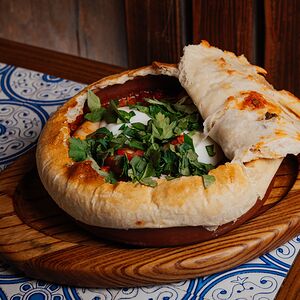 Шакшука с куриными колбасками, яйцом пашот под шапкой из теста