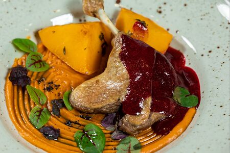 Утка конфи с тыквой, пюре из батата и соусом черная вишня