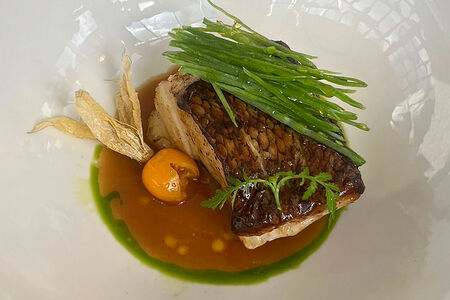 Чилийский сибас со сливочным понзу и молодым горошком