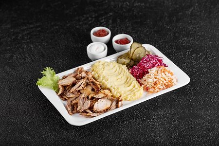 Шаурма на тарелке c гарниром, салатом и соусами