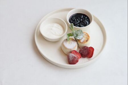 Домашние сырники со сметаной, вареньем и клубникой