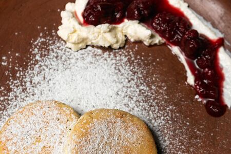 Сырники, политые вишневым соусом на красном вине