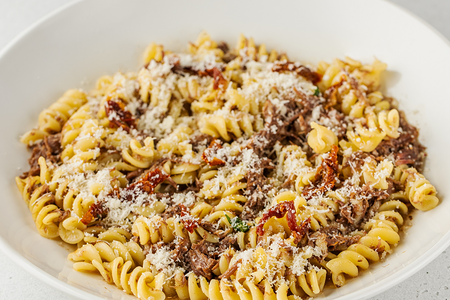 Фуззили с томлеными в портвейне щечками, вялеными томатами и сыром пармезан