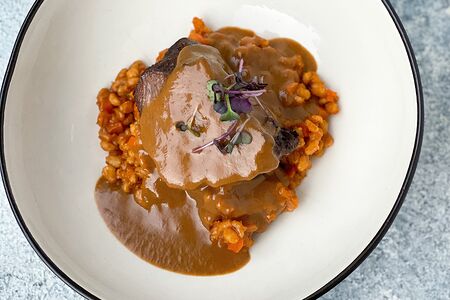 Томленые телячьи щеки с перловкой