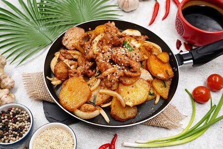 Острая говядина с картофелем на горячей сковороде