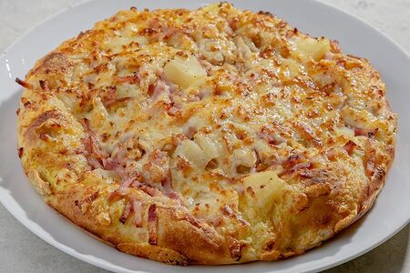 Пицца с ананасами и ветчиной