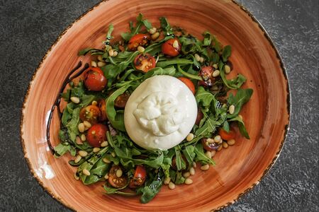Буррата с руколой и розовыми помидорами