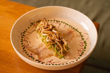 Сибас с цукини, чипсами из вешенок и сливочным понзу