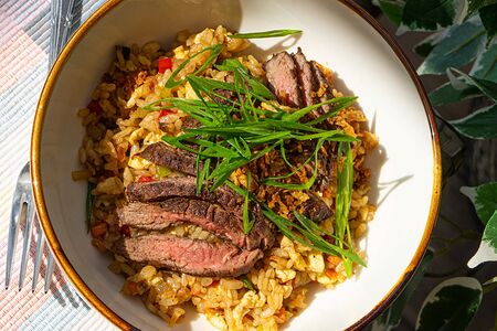 Жареный рис с говядиной, овощами и азиатским соусом