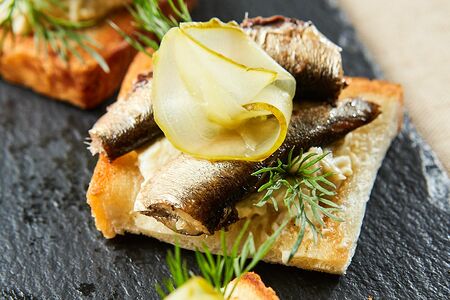 Бутеры из пшеничного хлеба с соленым огурцом и шпротами