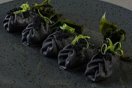 Черные пельмени с лососем, кальмаром и судаком