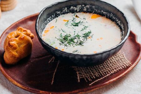 Уха на сливках по-фински с копченой форелью и расстегаем