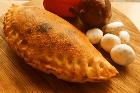 Кальцоне с ветчиной и грибами