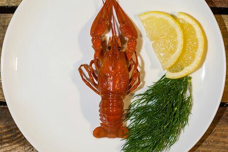 Крупные вареные раки с чесноком и помидорами