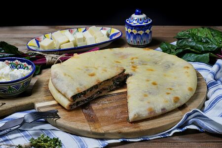 Осетинский пирог Сахараджин с сыром и свекольными листьями