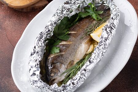 Форель, запеченная в травах