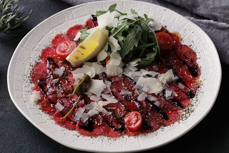 Карпаччо из говядины с рукколой, сладкими томатами и сыром пармезан