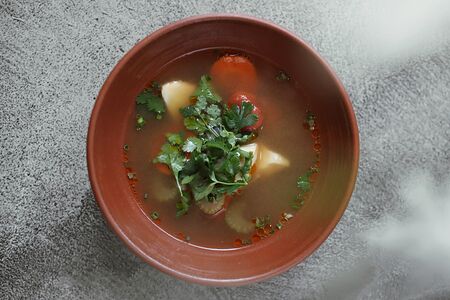 Уха из копченой белуги с узбекским томатом, маслом аджики