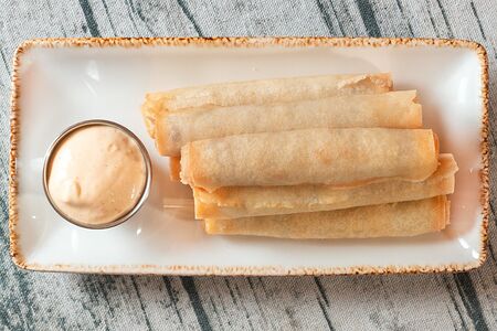 Жареные колбаски в тесте с острым сырным соусом