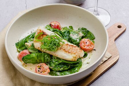 Филе трески на подушке из шпината с соусом шампань