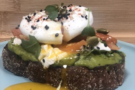 Бутерброд с лососем, гуакамоле, творожным сыром и яйцом пашот