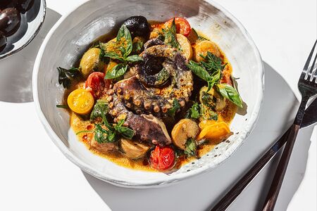 Осьминог с томатами и беби картофелем в соусе биск